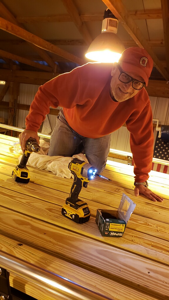 Photo of Dan installing roof deck.
