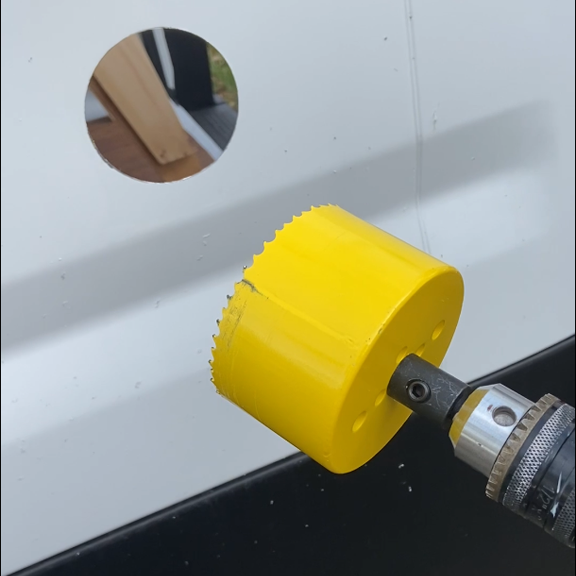 Photo of hole saw and fresh hole.